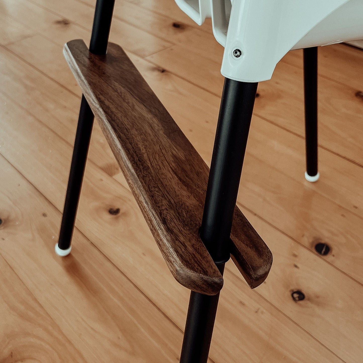 Close up of IKEA highchair footrest in Walnut timber